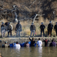 Protestors confront police in riot gear as a haze of pepper spray wafts over the river on November 2, 2016 (AP Photo/John L. Mone)